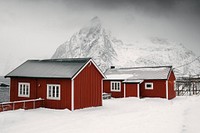 Red cabins on a snowy Sakrisoy island, Norway