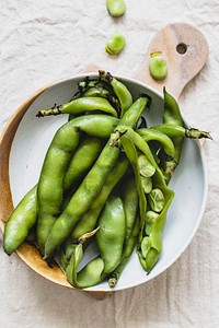 Fresh organic broad beans in a bowl aerial view