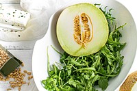 Melon with rocket salad in a bowl