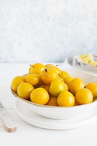 Fresh organic mirabelle plums in a bowl