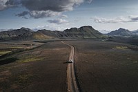 SUV car driving in the countryside drone shot