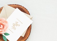 Wedding card with rose on a wooden plate