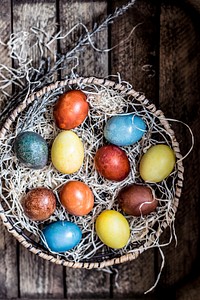 Colored Easter eggs in a basket. Visit <a href="https://monikagrabkowska.com/" target="_blank">Monika Grabkowska</a> to see more of her food photography.