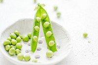 Closeup of peas in a white cup. Visit <a href="https://monikagrabkowska.com/" target="_blank">Monika Grabkowska</a> to see more of her food photography.