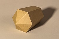 Golden hexagonal prism paper craft on a beige background