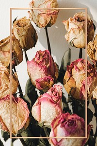 Gold frame over a bouquet of dried roses