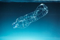 Single use plastic bottle floating in the ocean