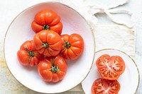 Natural fresh organic tomatoes in white bowl