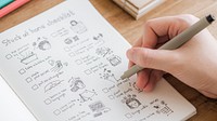 Girl doodling and making a checklist in a notebook