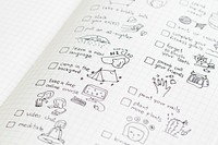 Social isolation doodle style checklist in a notebook