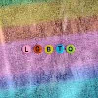 LGBTQ word beads lettering colorful background 