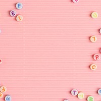 Alphabet beads border pink background