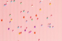 Beads on pink wavy paper wallpaper background