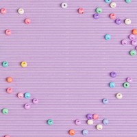 Pastel beads border purple background