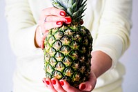 Woman with organic pineapple summer fruit