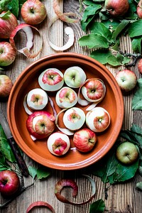 Peeled apples in bowl on wooden table