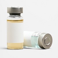 Blank vaccine label on injection glass bottles with colored liquid