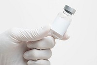 Scientist&#39;s hand holding medicine glass vial with blank white label
