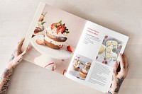 Woman reading from a recipe cookbook flat lay