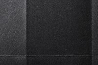 Folded black paper texture background