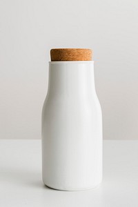 Minimal white metal container sealed with a cork