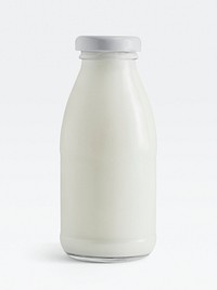 Fresh milk in a glass bottle on white background