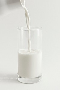 Close up of pouring fresh milk into a glass