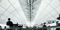 People on a moving walkway in a passenger terminal at the airport