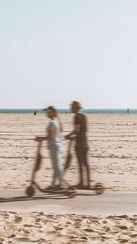 Couple riding a scooter by the beach mobile screen wallpaper