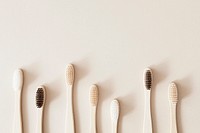 Bamboo toothbrushes on a beige background