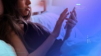 Woman playing on her phone in bed