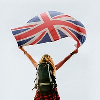 Caucasian woman holding Britain&#39;s flag