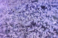 Purple frost on a window background