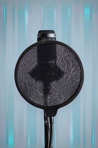 Professional condenser microphone with a pop filter in a studio