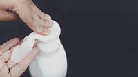 Man cleaning hands with a soap dispenser