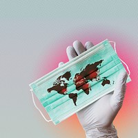 Hand wearing glove holding contaminated world map on surgical mask