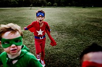 Superhero kids playing at the park