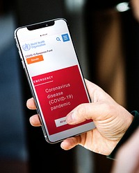 <br />Woman reading coronavirus information from a phone mockup with editorial graphic from <a href="https://www.who.int/">https://www.who.int/</a> accessed on April 6th 2020. LA, USA - JUNE 26, 2018