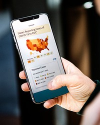 Woman reading coronavirus updates from a phone screen mockup with editorial graphic from <a href="https://www.cdc.gov/coronavirus/2019-ncov/cases-updates/cases-in-us.html">https://www.cdc.gov/coronavirus/2019-ncov/cases-updates/cases-in-us.html</a> accessed on April 8th 2020. BANGKOK, THAILAND - JUNE 26, 2019
