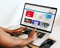 Woman reading coronavirus updates from a laptop mockup with editorial graphic from <a href="https://www.who.int/" target="_blank">https://www.who.int</a> accessed on April 6th 2020. LOS ANGELES, USA - MARCH 27, 2019<br /><br /> 
