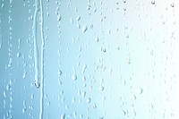 Rain drops on glass blue background 