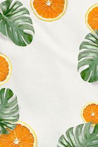 Green Monstera leaves and orange background