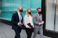 Business people in medical masks walking to the office 