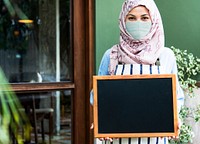 Muslim woman in mask new normal open signboard coffee shop