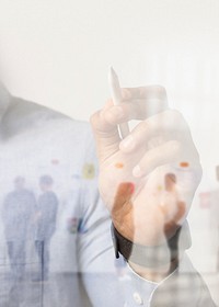 Businessman writing on invisible screen with diverse business team background