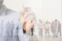 Businessman writing on invisible screen with diverse business team background