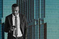 Black businessman on phone over city background