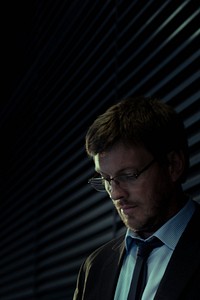 Businessman in suit standing near window