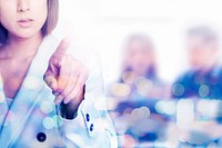 Young businesswoman in suit pointing on invisible screen with team background