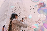 Woman taking a picture in city 